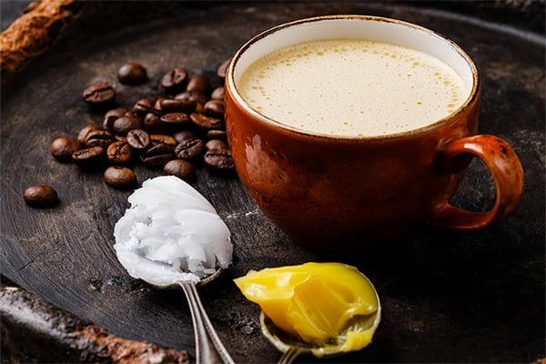 Homemade bulletproof coffee with coconut oil and ghee or butter