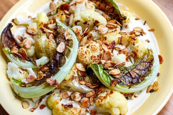 roasted cauliflower with creamy cashew garlic sauce and toasted almonds