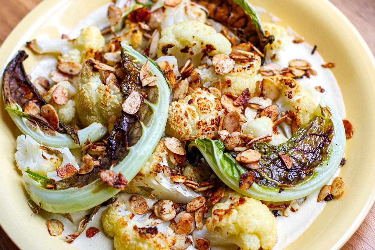 roasted cauliflower with creamy cashew garlic sauce and toasted almonds
