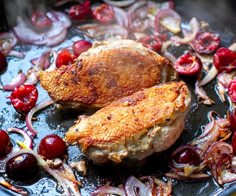Duck breasts with crispy skin in a frying pan