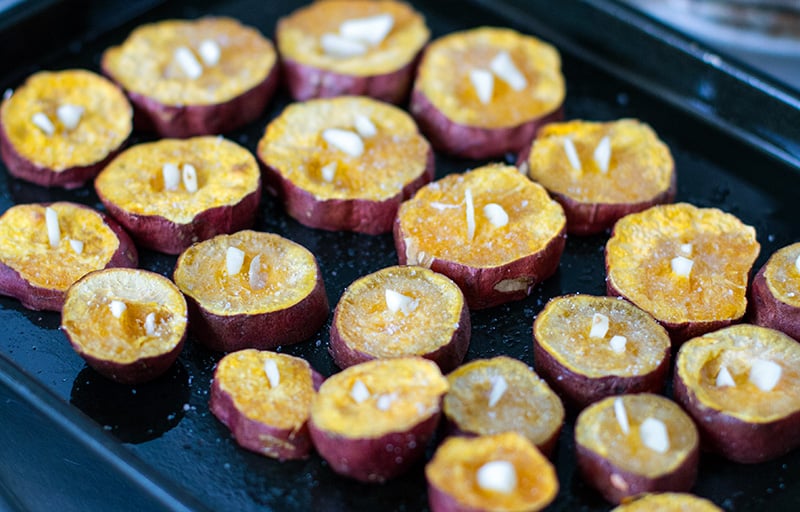 Garlic sweet potatoes - inserting garlic into almost cooked potatoes when roasting