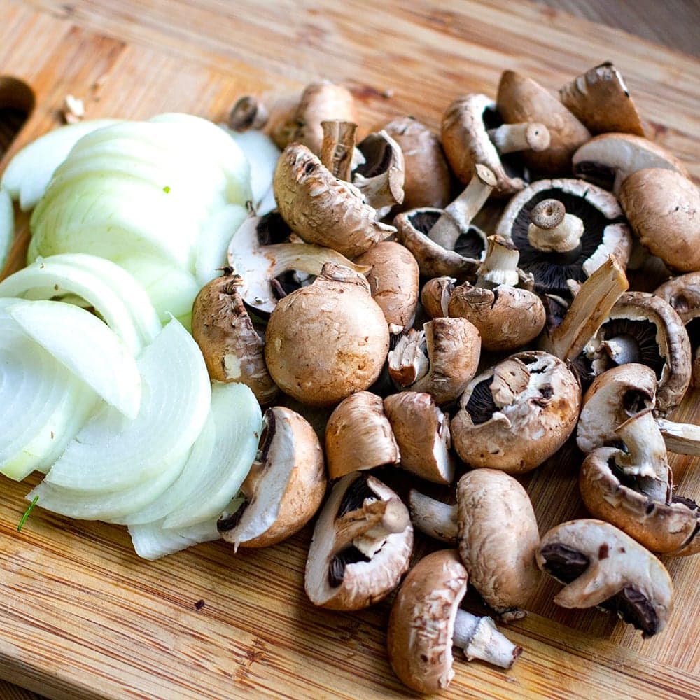 Sliced onions and mushrooms for sheet pan bake with chicken