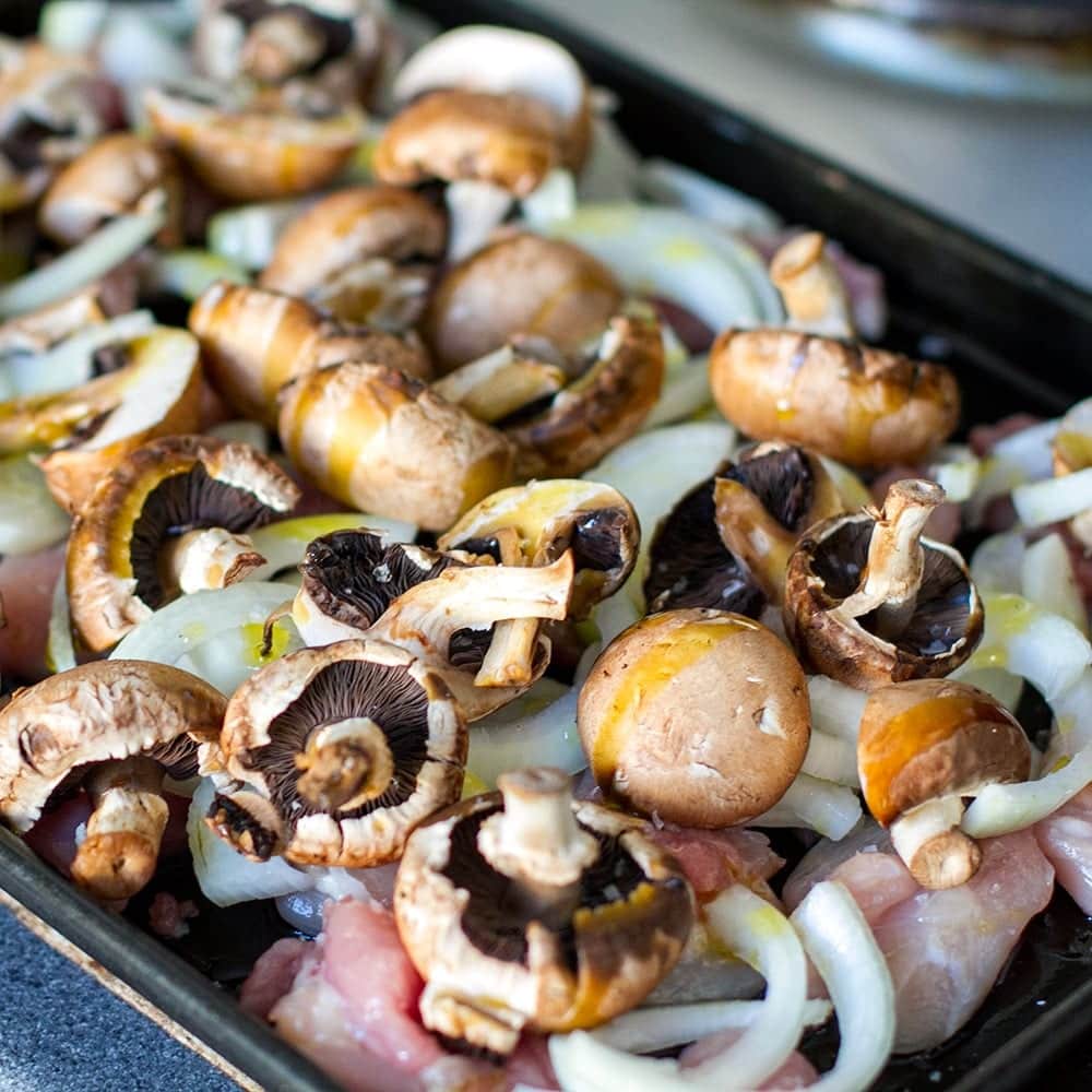 Chicken mushrooms and onions on a baking tray