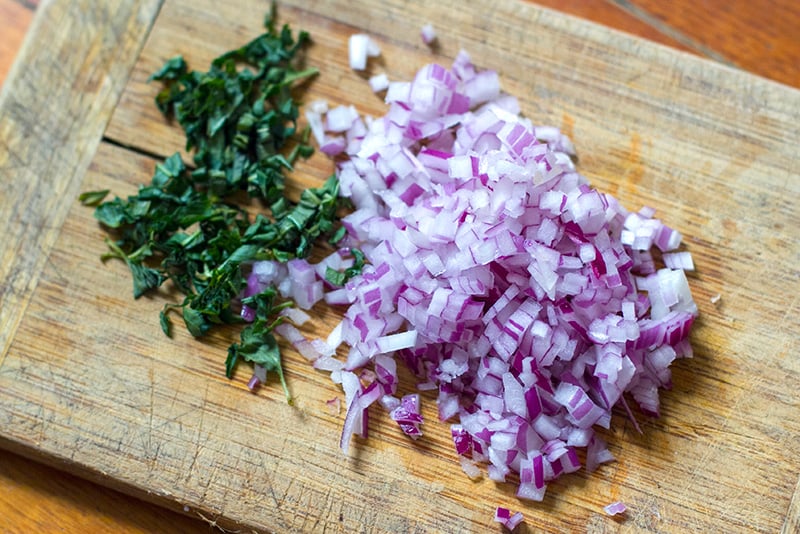 Diced red onions and basil for salsa