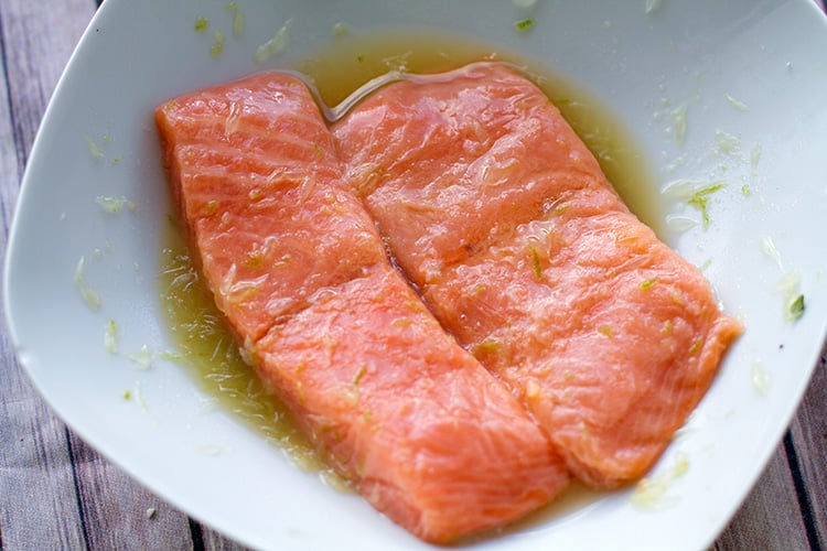 Marinating the salmon in citrus dressing