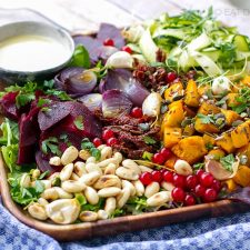 Fall salad with roasted squash and tahini garlic dressing