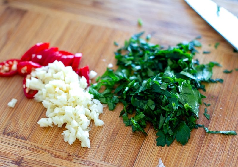 Seasoning the squid with garlic, parsley and chili