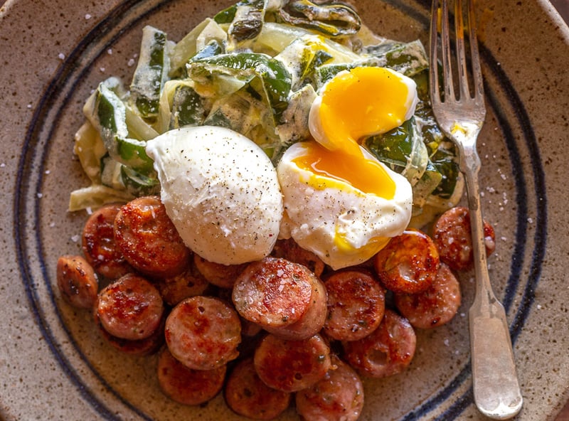 Creamy peppers with poached eggs and sausage