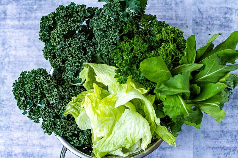 Leafy greens for a salad: kale, rocket, lettuce and parsley