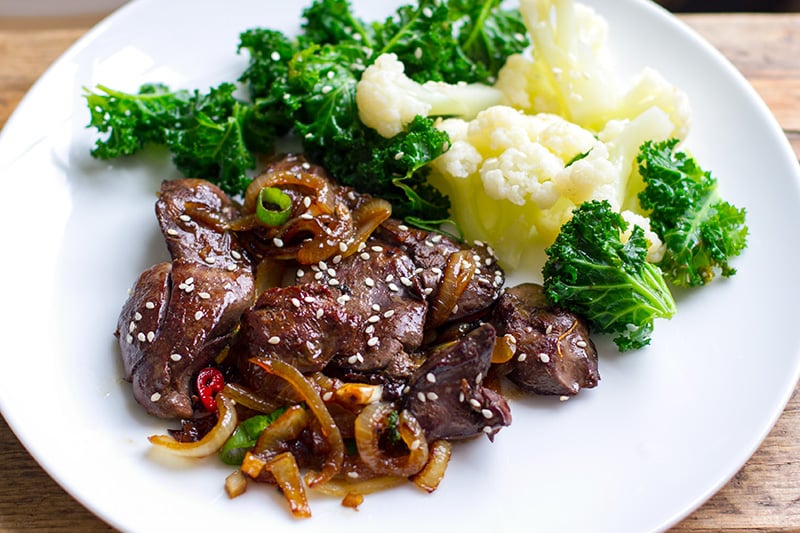 Chicken livers recipe with onions and Asian sauce with vegetables