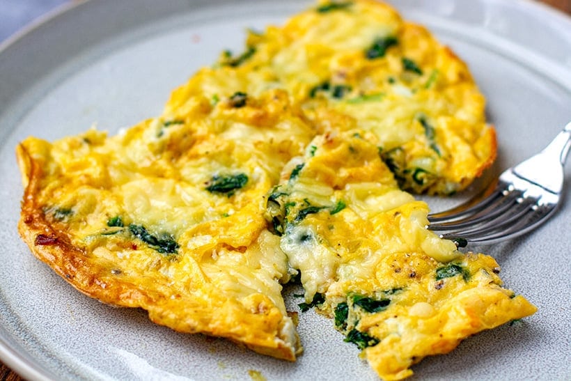 Spinach and grilled cheese omelette on a plate