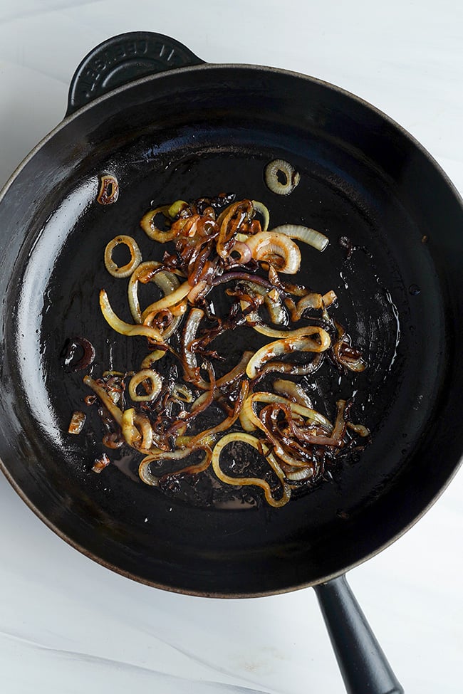 Grilled onions in a frying pan for burgers