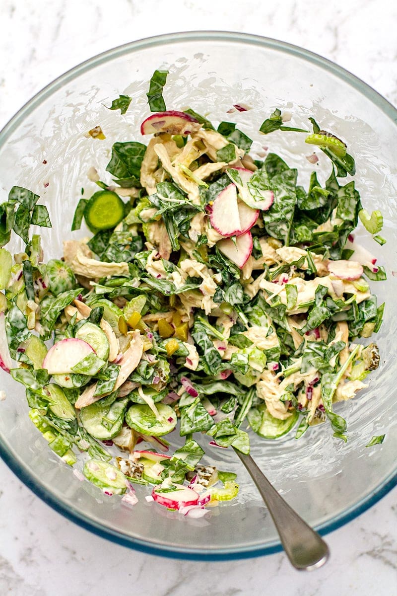 Keto Chicken salad with rotisserie chicken, baby spinach and creamy dressing tossed in a bowl