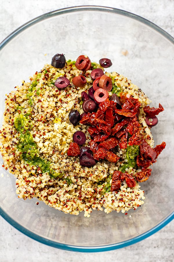 Quinoa mixed with olives, sun-dried tomatoes and some of the dressing