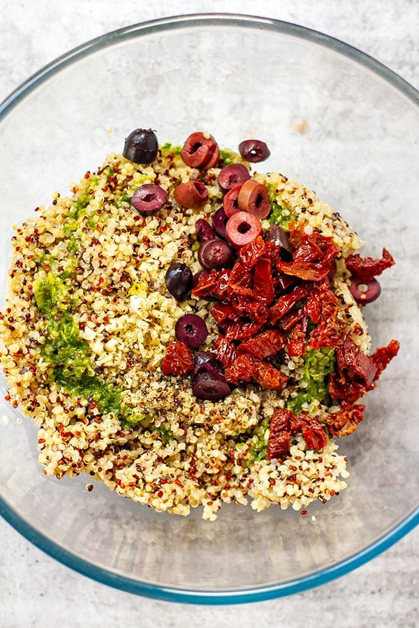 Quinoa mixed with olives, sun-dried tomatoes and some of the dressing