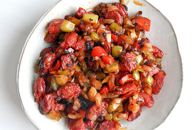 Cooked chorizo with onions and peppers in a bowl for tacos