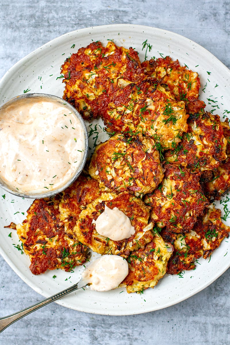 You will love these cheesy, crispy tuna cabbage fritters with spicy garlicky mayonnaise dipping sauce. Super easy to make, the cabbage patties are pan-fried in a little oil and can be served for lunch, brunch or dinner. I love it with a big salad for a satiating, nutritious meal. Also great as finger food! Keto, low-carb, gluten-free. 