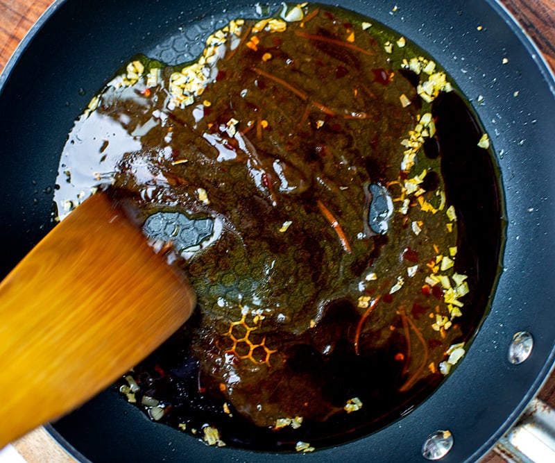 Stirring the sauce before it caramelises