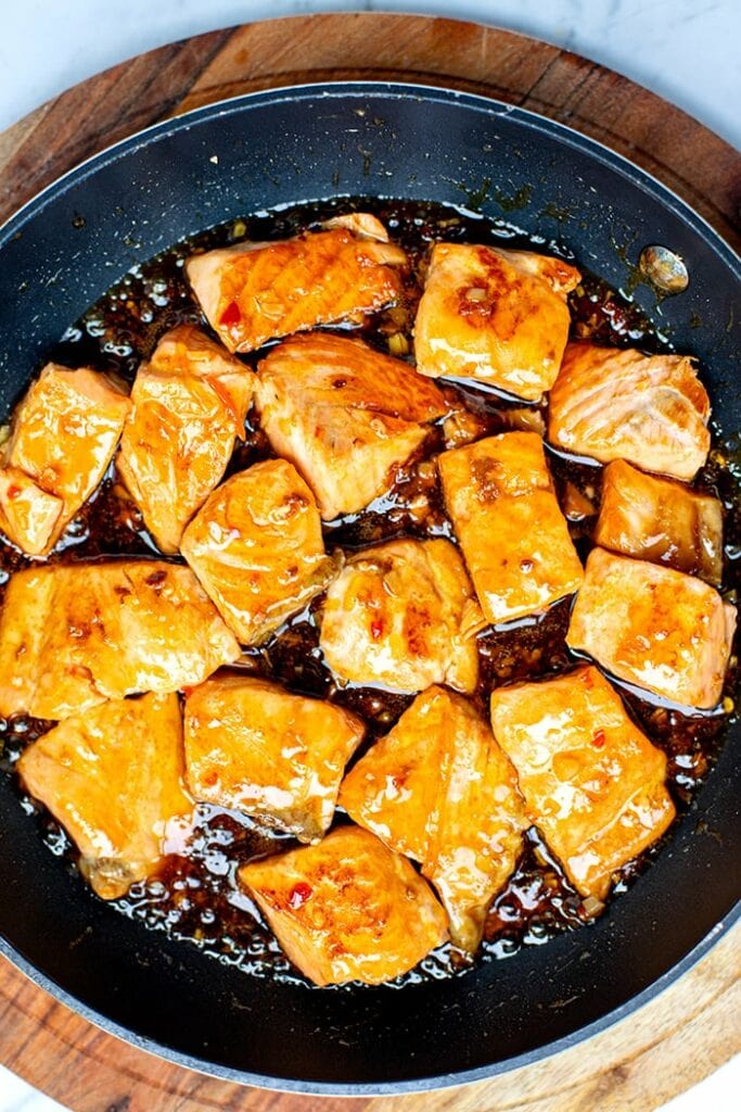 Glazed salmon bites in a pan