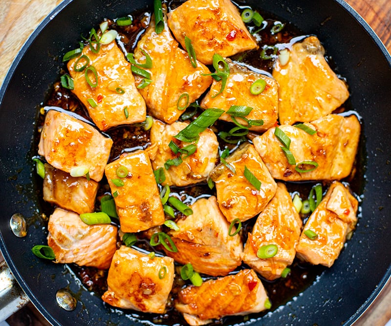 Salmon with sweet chili soy glaze and green onions on top