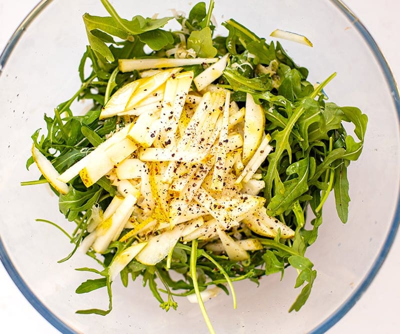 Lemon maple dressing over arugula salad