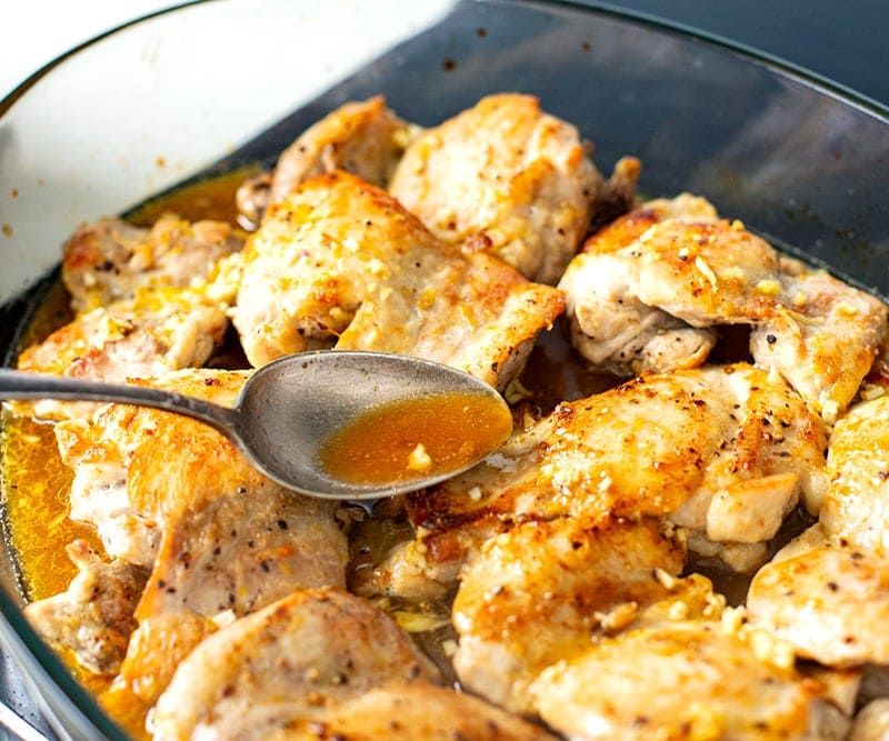 Basting chicken with honey lemon sauce