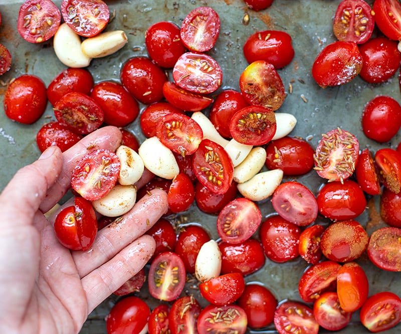 Toss tomatoes and garlic in olive oil