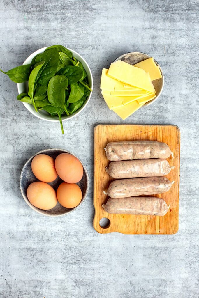 Breakfast Burger ingredients - sausages, eggs, cheese and spinach