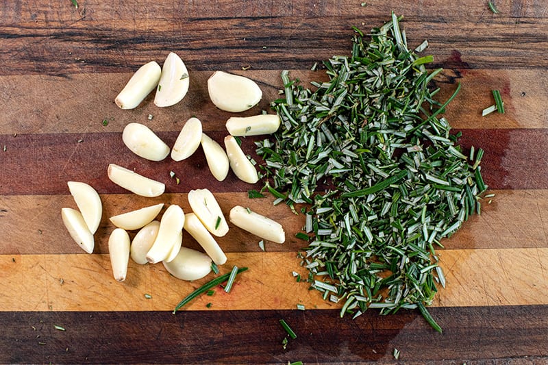 Chopped rosemary and garlic on a board