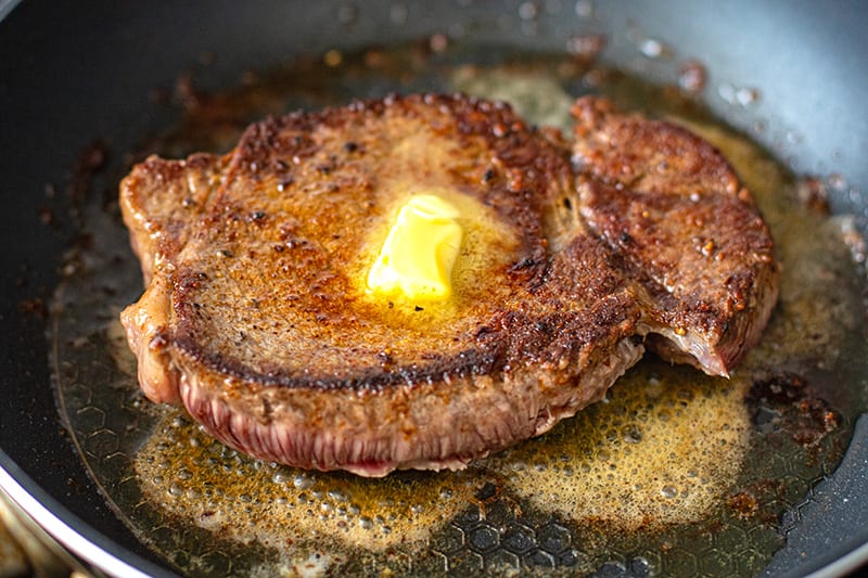 Grilled Butter Steak in a pan with butter on top