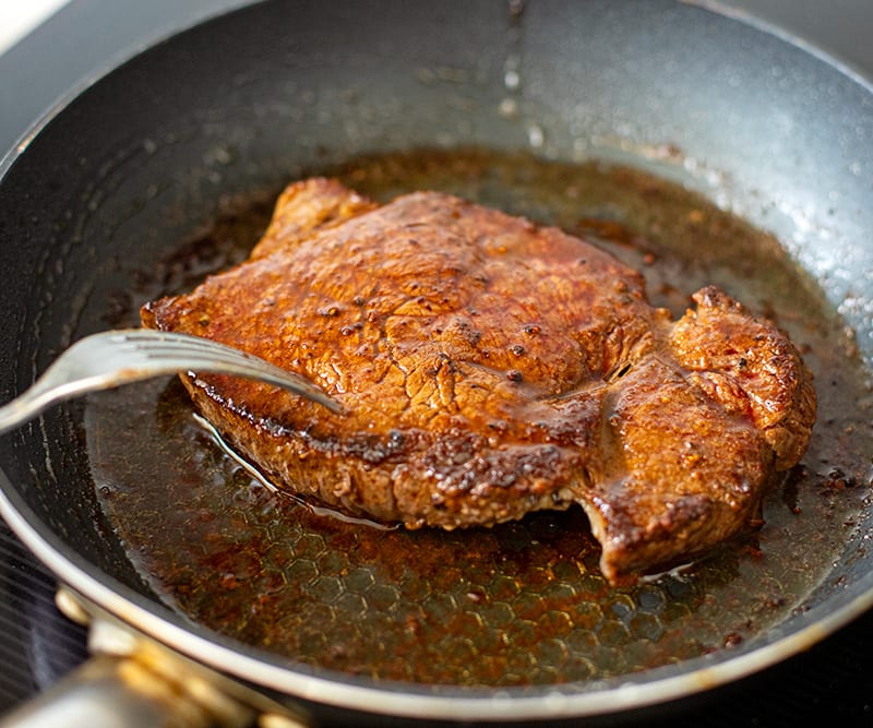 Coating the steak with cumin butter