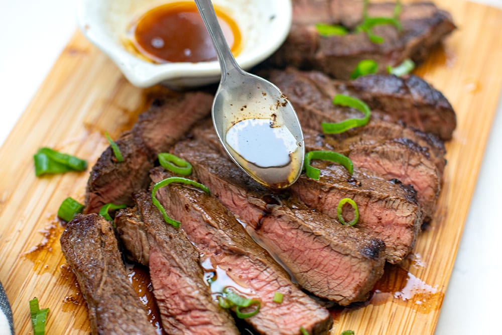 Drizzle the buttery juices over the sliced steak