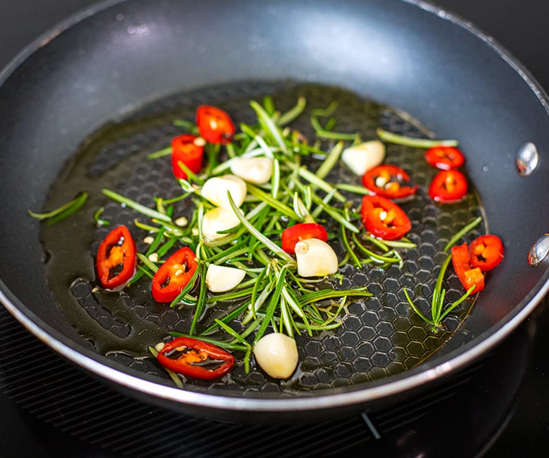 pan frying rosemary chili and garlic