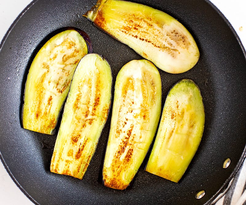 Frying eggplant slices in a pan