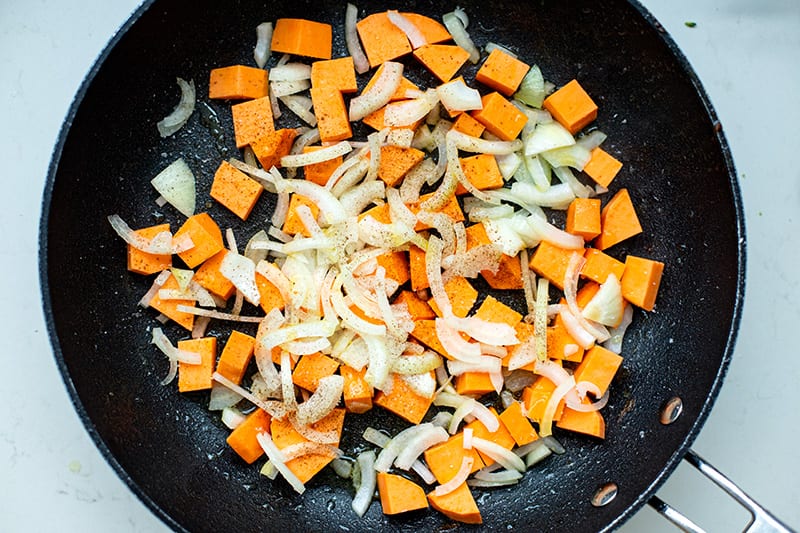 Sweet potatoes and onions in a pan