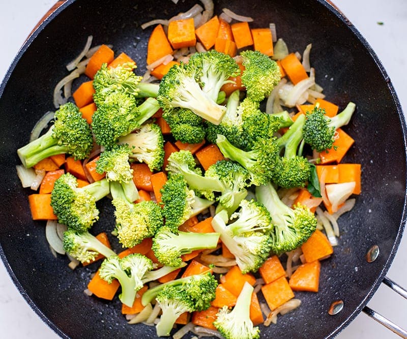 Add broccoli and cook under lid