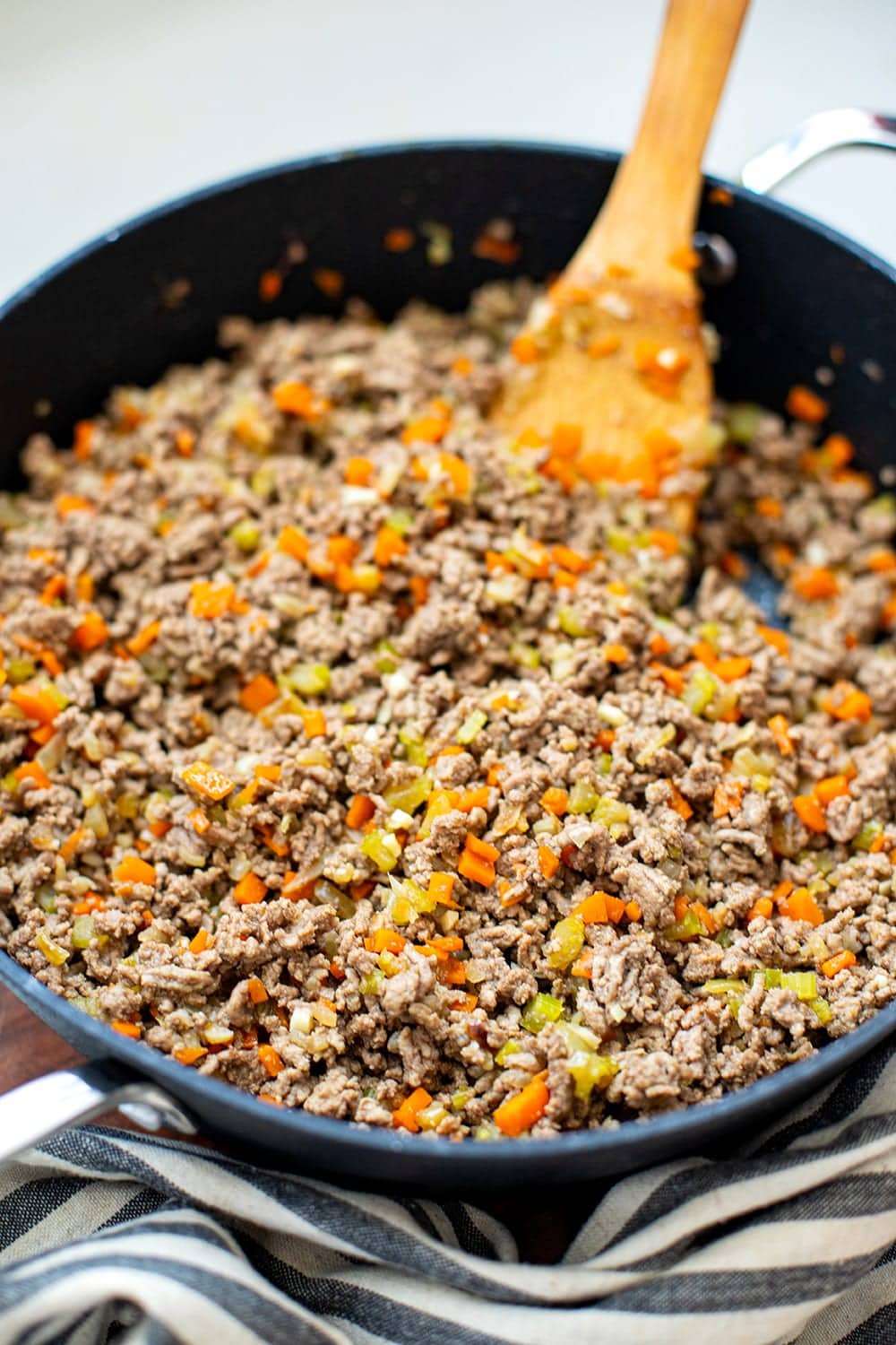 Use Your Potato Masher To Break Up Ground Meat in the Skillet