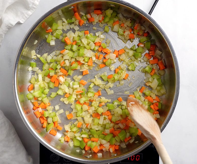 Sauteed onions, carrots and celery in the pan