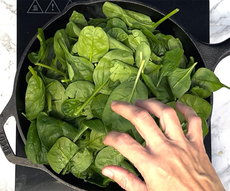 Add spinach to skillet