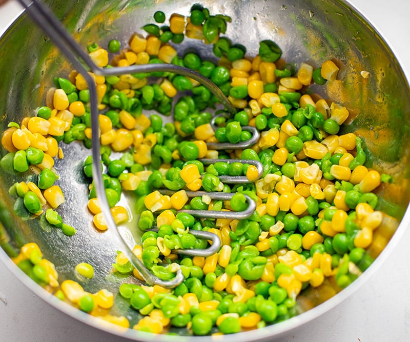 Mashing corn and peas