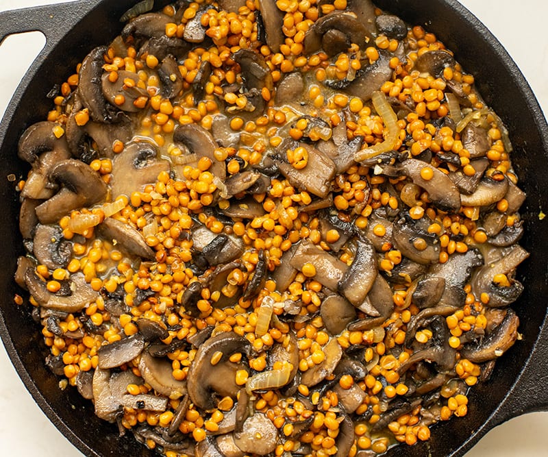 Lentils and mushrooms in a pan
