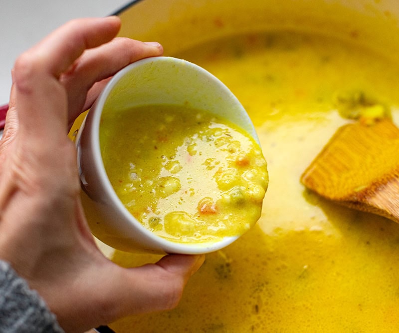 Adding flour slurry mixed with soup back to pot