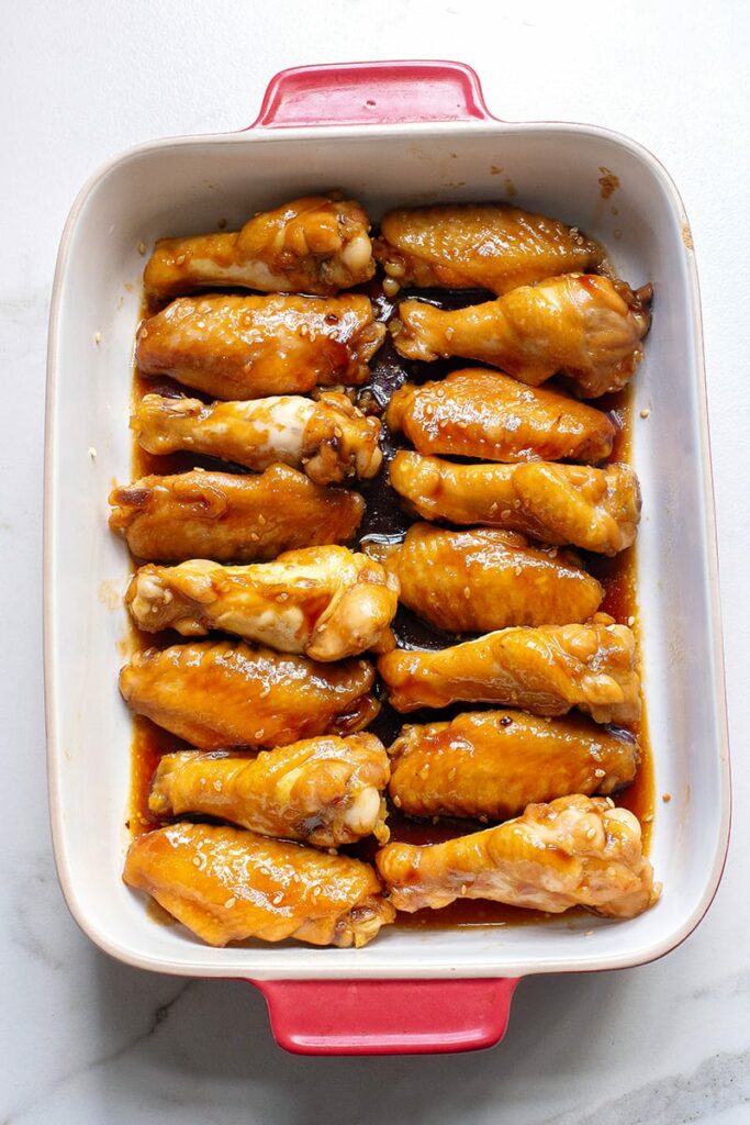 Finished wings in a baking dish with glaez