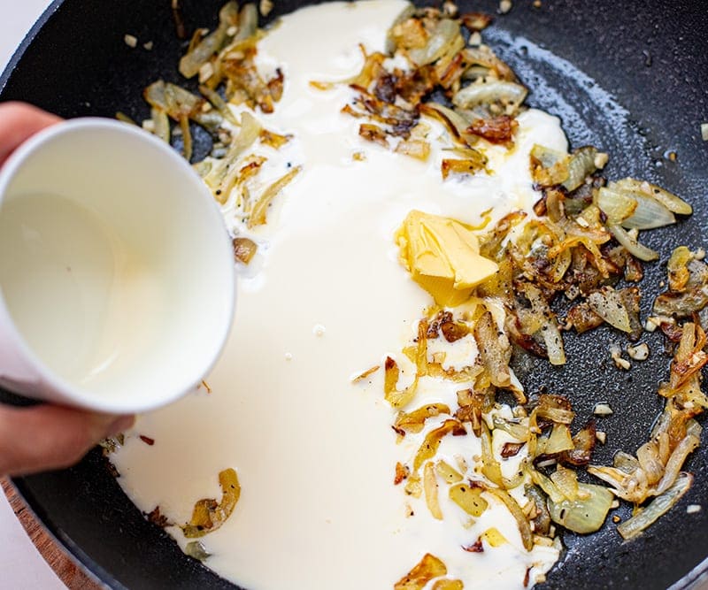 Add cream to the onions and garlic