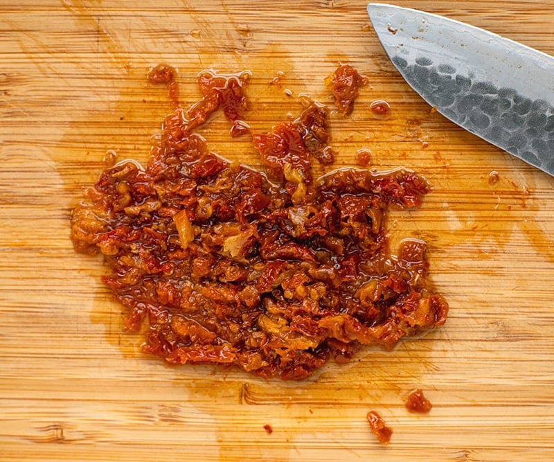 Chopped sun-dried tomatoes for Avocado Turkey Sandwich With Sun-Dried Tomato Aioli