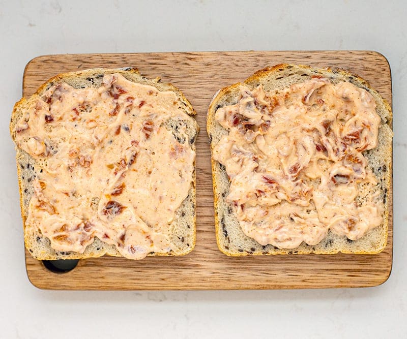 Spread on bread for Avocado Turkey Sandwich With Sun-Dried Tomato Aioli