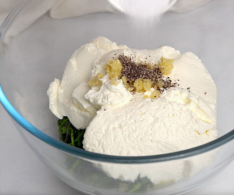 mixing cottage cheese, ricotta and spinach