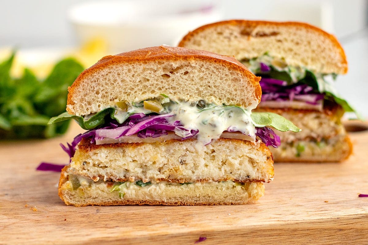 fish sandwich with tartar sauce and red cabbage