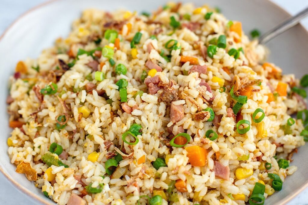 Fried rice with leftover ham, carrots, peas and corn, scallions for garnish.