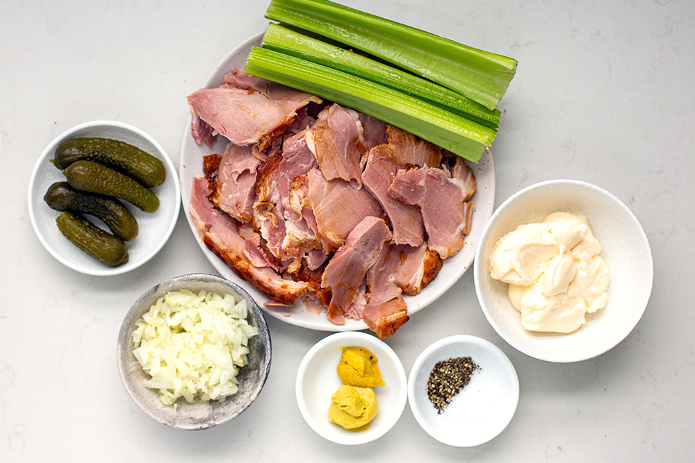 salad ingredients: ham, celery, mayonnaise, onions, pickles, mustards, and pepper.